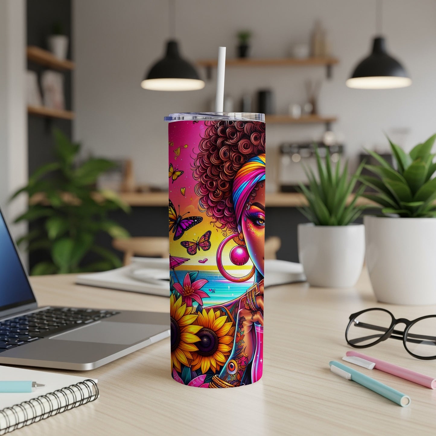 Pink and yellow tumbler with colorful floral and butterfly design.