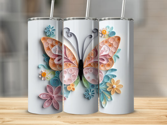 Three white tumblers adorned with pastel quilled paper butterflies and flowers.