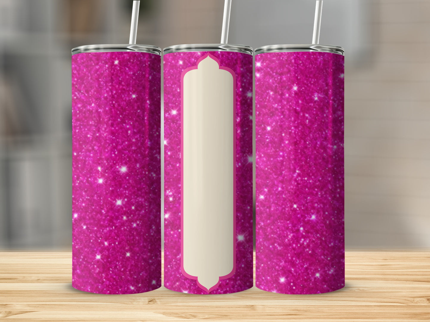 Pink glitter tumbler with cream-colored centerpiece on wooden surface.
