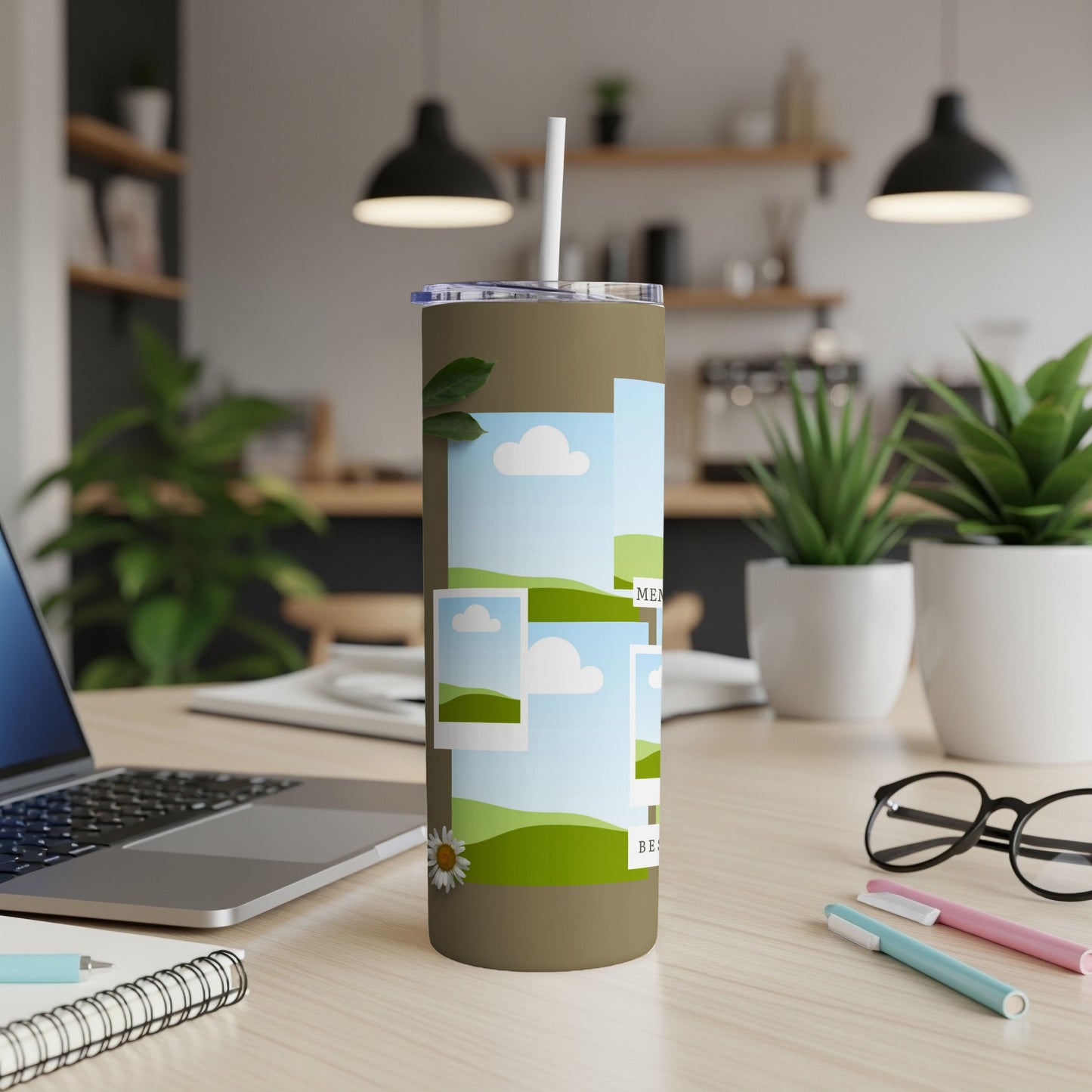 Tan tumbler with scattered photo frames of grassy hills and blue skies.