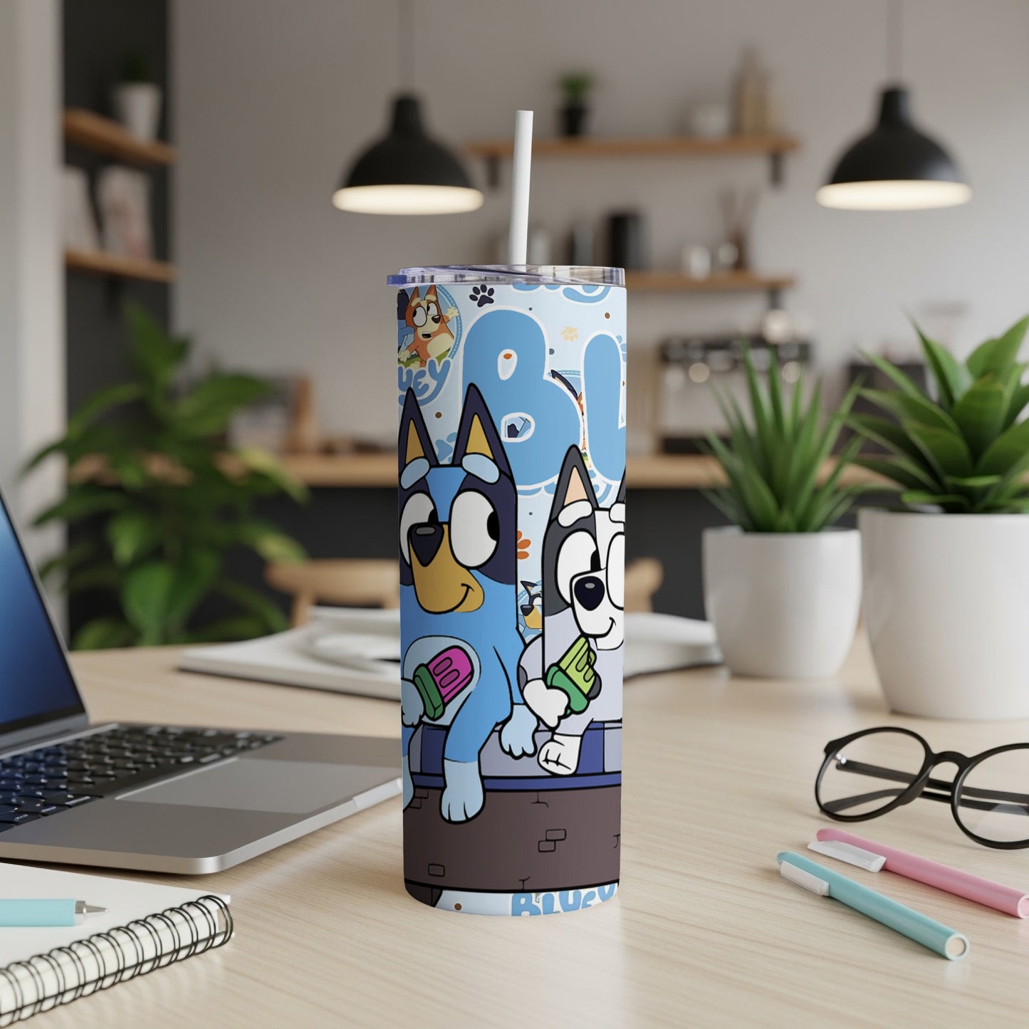 Bluey and Bingo characters on a blue patterned tumbler with straw.