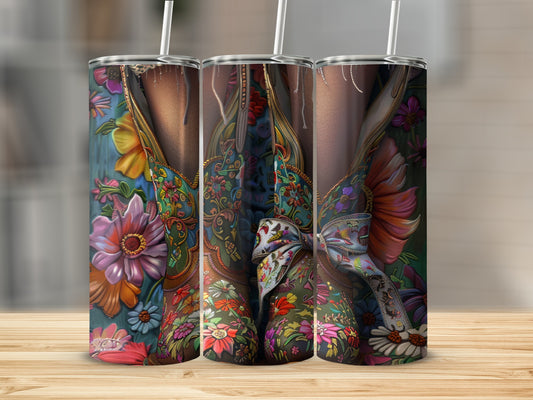 Three tumblers with colorful floral western boot designs, tied with ribbons.