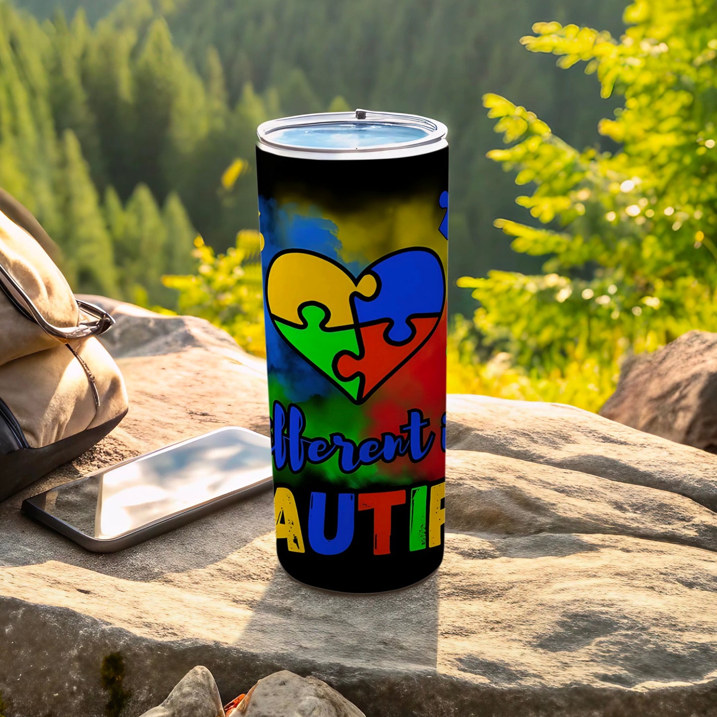 Black tumbler with puzzle heart design and "Different Not Less" text.