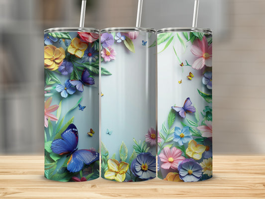 Three tumblers with floral and butterfly designs on a wooden surface.