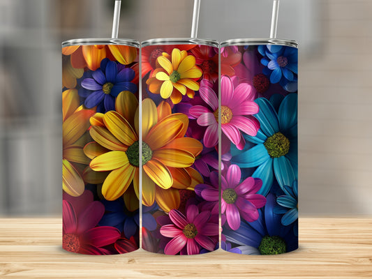 Three colorful tumblers with vibrant floral patterns on a wooden surface.