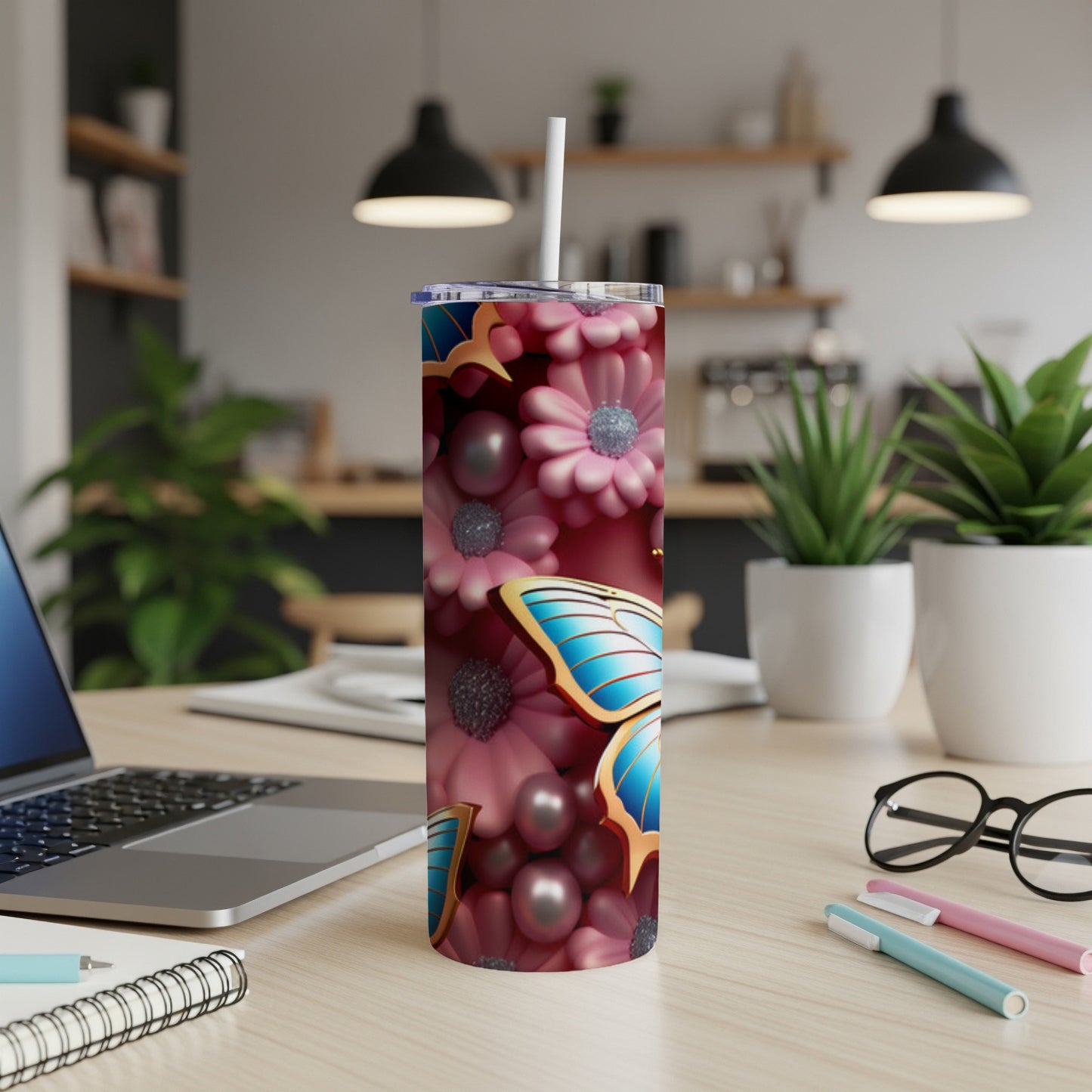 Tumbler with blue butterfly and pink floral design.