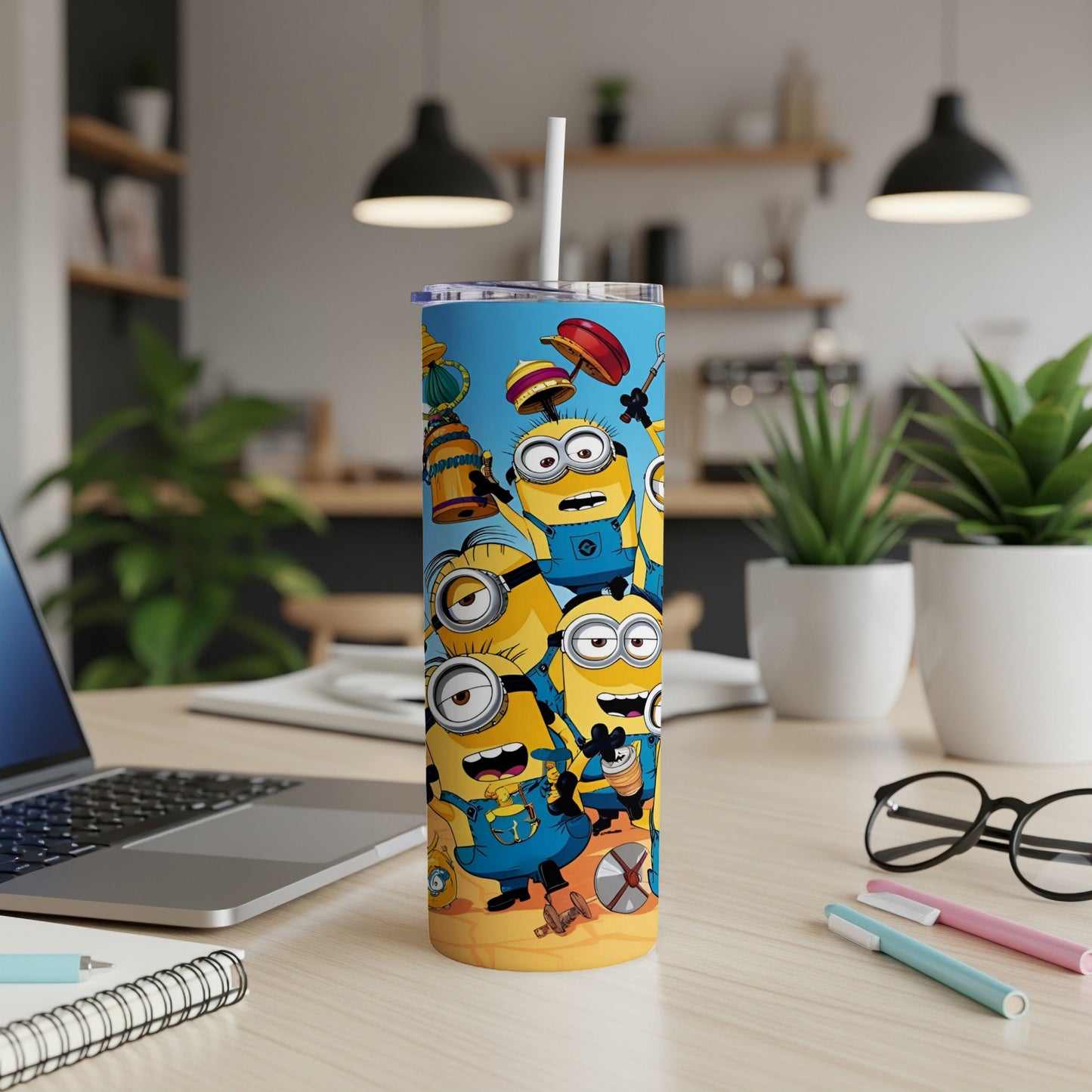Minions on a beach scene with straw in a tumbler cup.