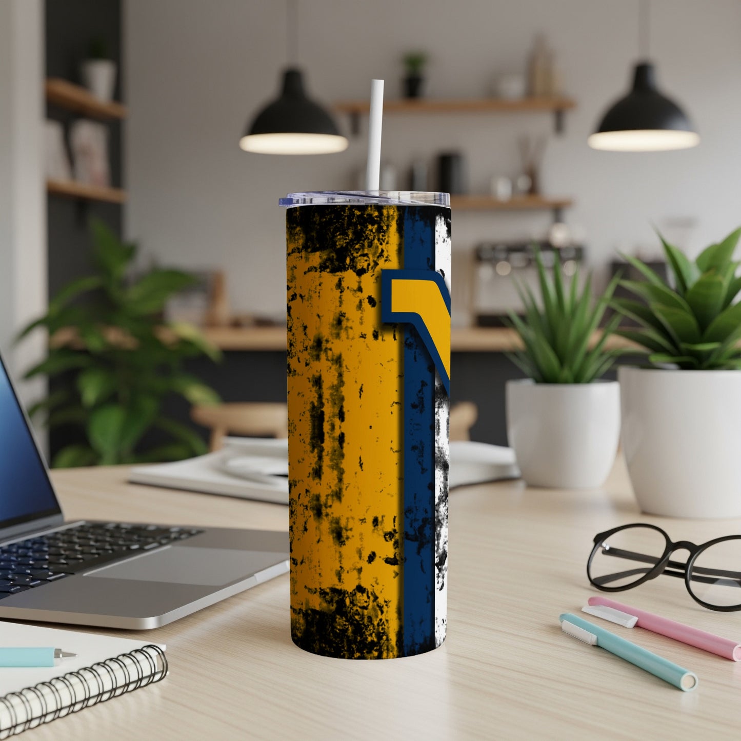 Tumbler with abstract yellow, blue, and black design, featuring a straw.