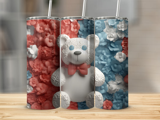 Three tumblers with floral patterns and a teddy bear, two with red and white flowers, one with blue and white.