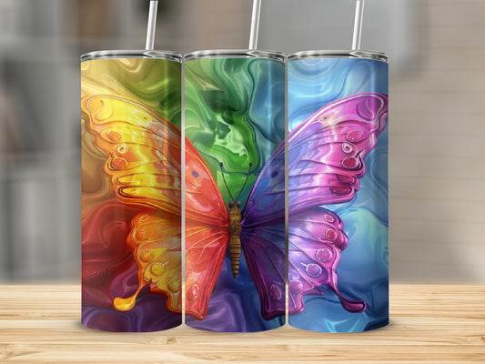 Three tumblers with colorful, abstract butterfly designs in a row.