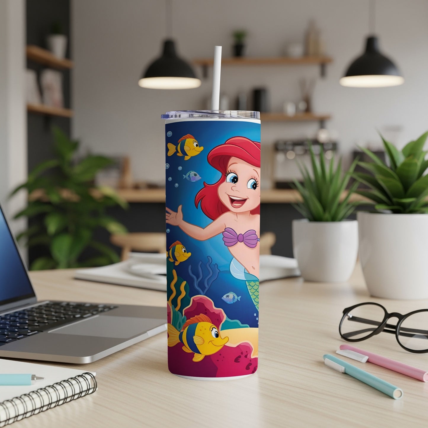 Ariel and Flounder on a tumbler with a beach scene.