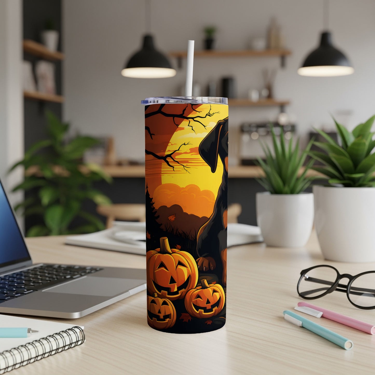 Dachshund with pumpkins and moon on Halloween-themed tumbler.