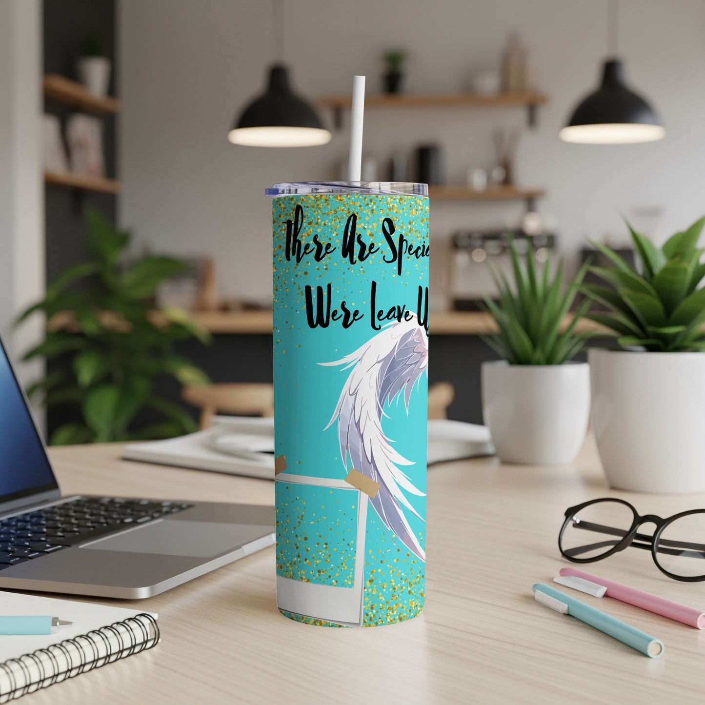 Turquoise tumbler with gold glitter, angel wings, and text.