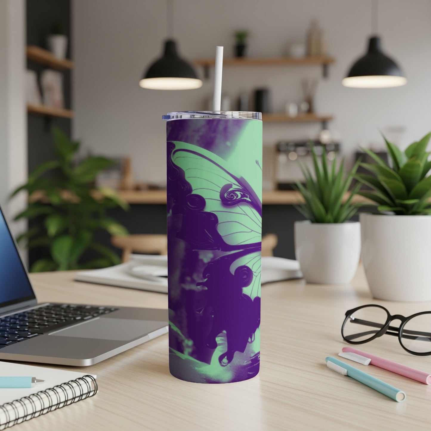 Purple butterfly graphic on a mint green skinny tumbler with straw.