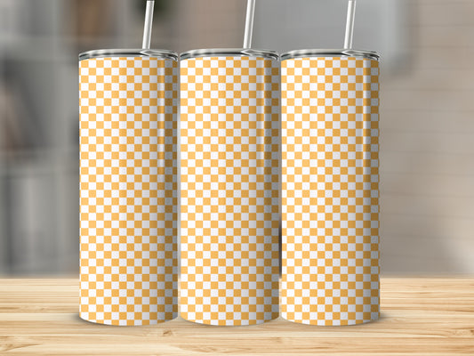 Three tall tumblers with a yellow and white checkerboard pattern on a wooden surface.