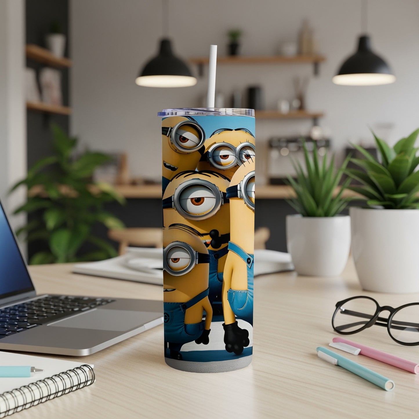 Minions on a blue tumbler with a white straw.