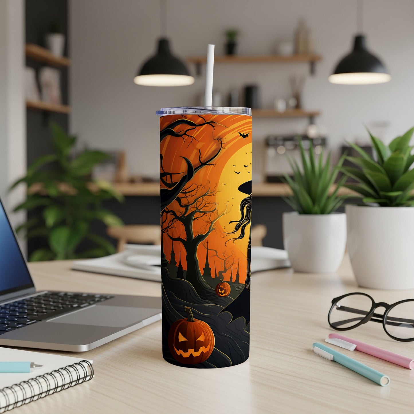 Halloween tumbler with witch, bats, pumpkins, and spooky trees on an orange sky.