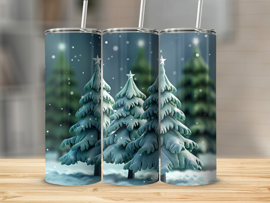 Three tumblers with a snowy Christmas tree design and straws.