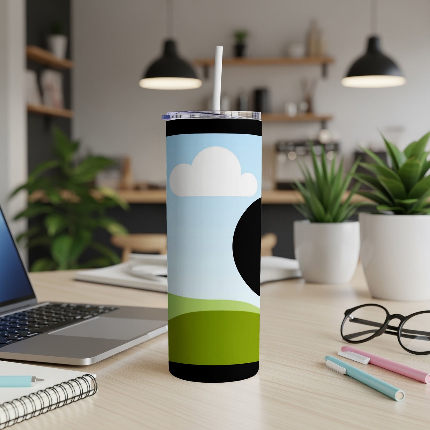 Tumbler with a sky, cloud, and green hills design and black circle.