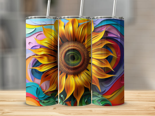 Three tumblers with sunflower and colorful abstract designs on a wooden surface.