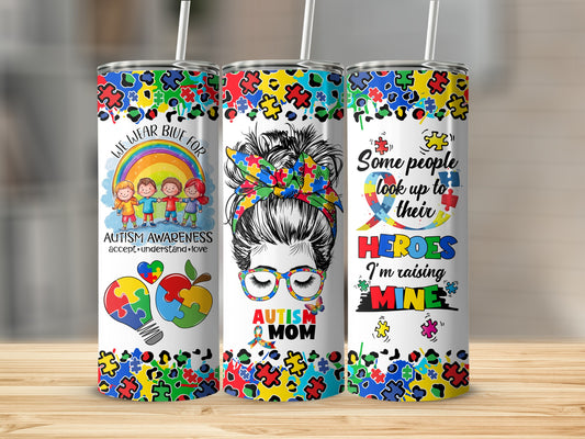 Autism awareness tumbler with puzzle pieces, rainbow children, and "Autism Mom" text.