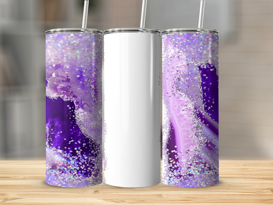 Three tumblers on a wooden surface, two with purple geode design and glitter.