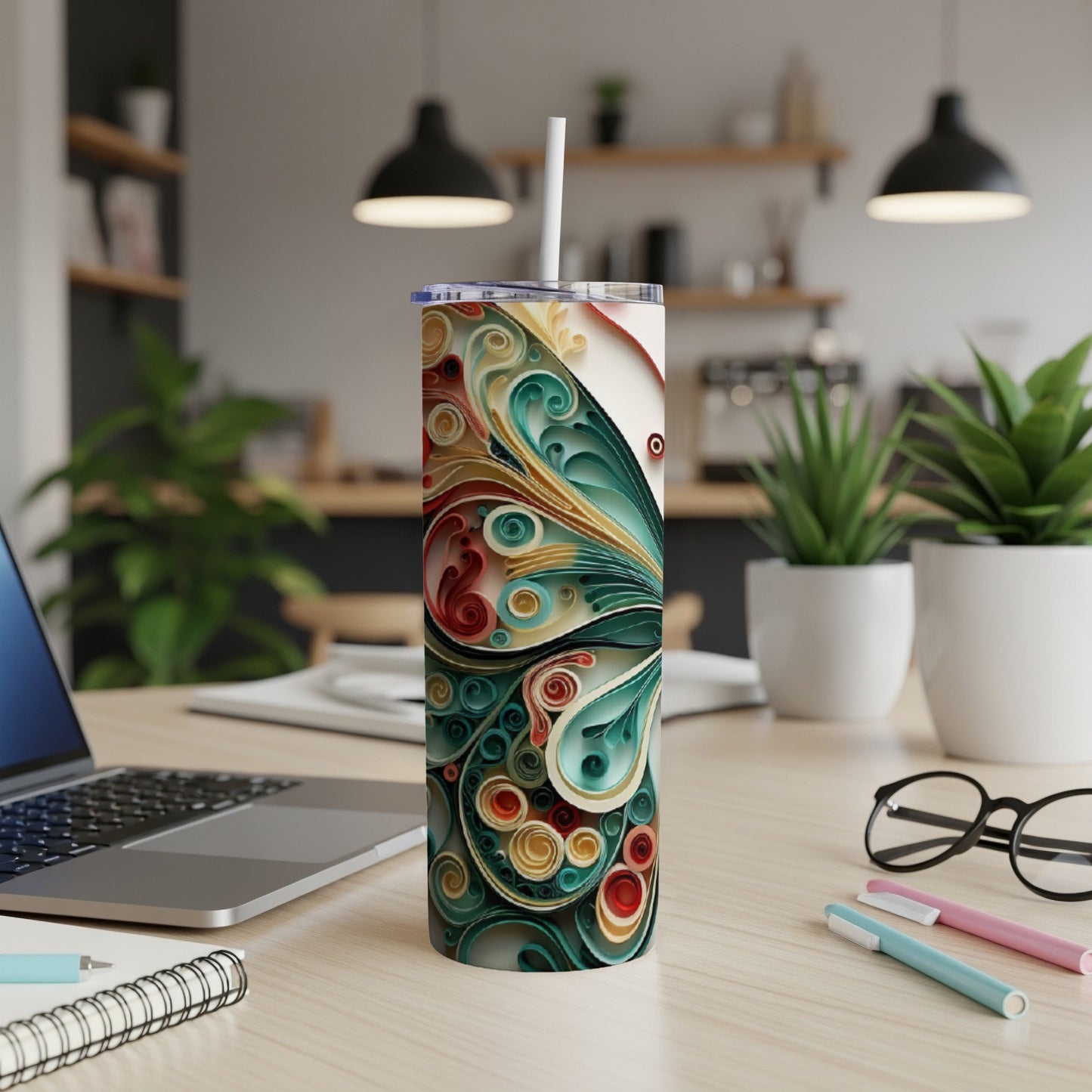 Tall tumbler with a colorful, abstract butterfly design on a desk.