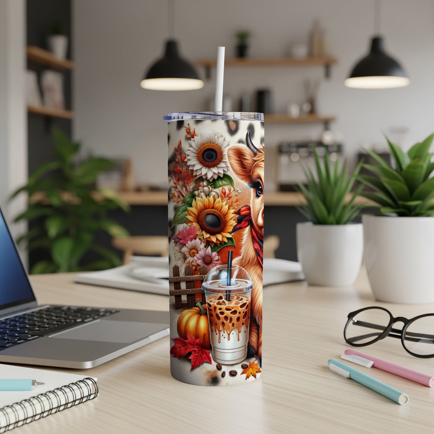 Cow and sunflowers on a tumbler with iced coffee and pumpkin.