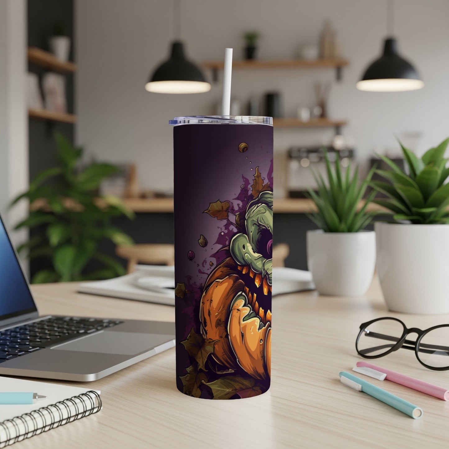Halloween tumbler with a scary zombie pumpkin design and falling leaves.