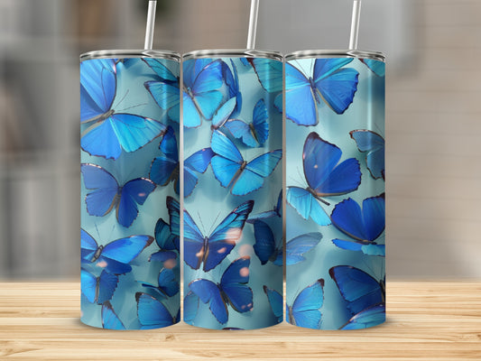 Three blue butterfly tumblers on a wooden surface.