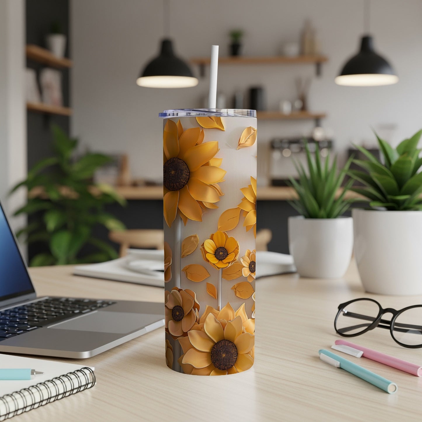 Tall tumbler with a sunflower floral pattern, featuring a straw and lid.