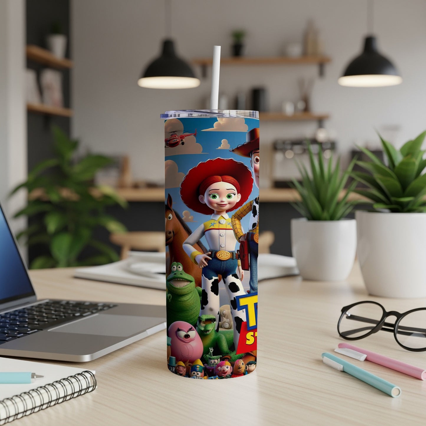 Toy Story characters on a white tumbler with a straw, on a desk.