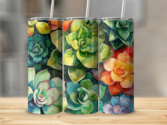 Three tumblers with colorful succulent floral art, lined up on a wooden surface.