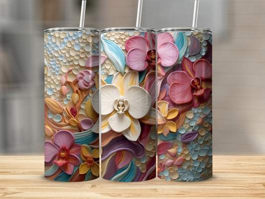 Three tumblers adorned with colorful raised floral designs on a wooden surface.