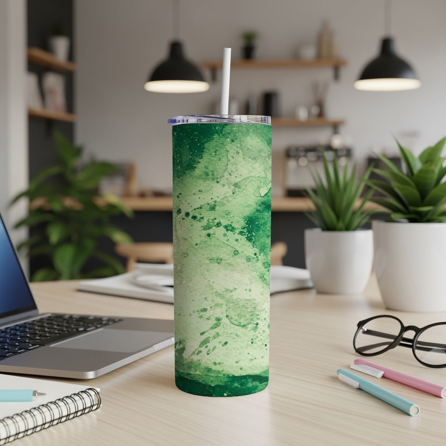 Green watercolor splatter insulated tumbler with white straw and lid.