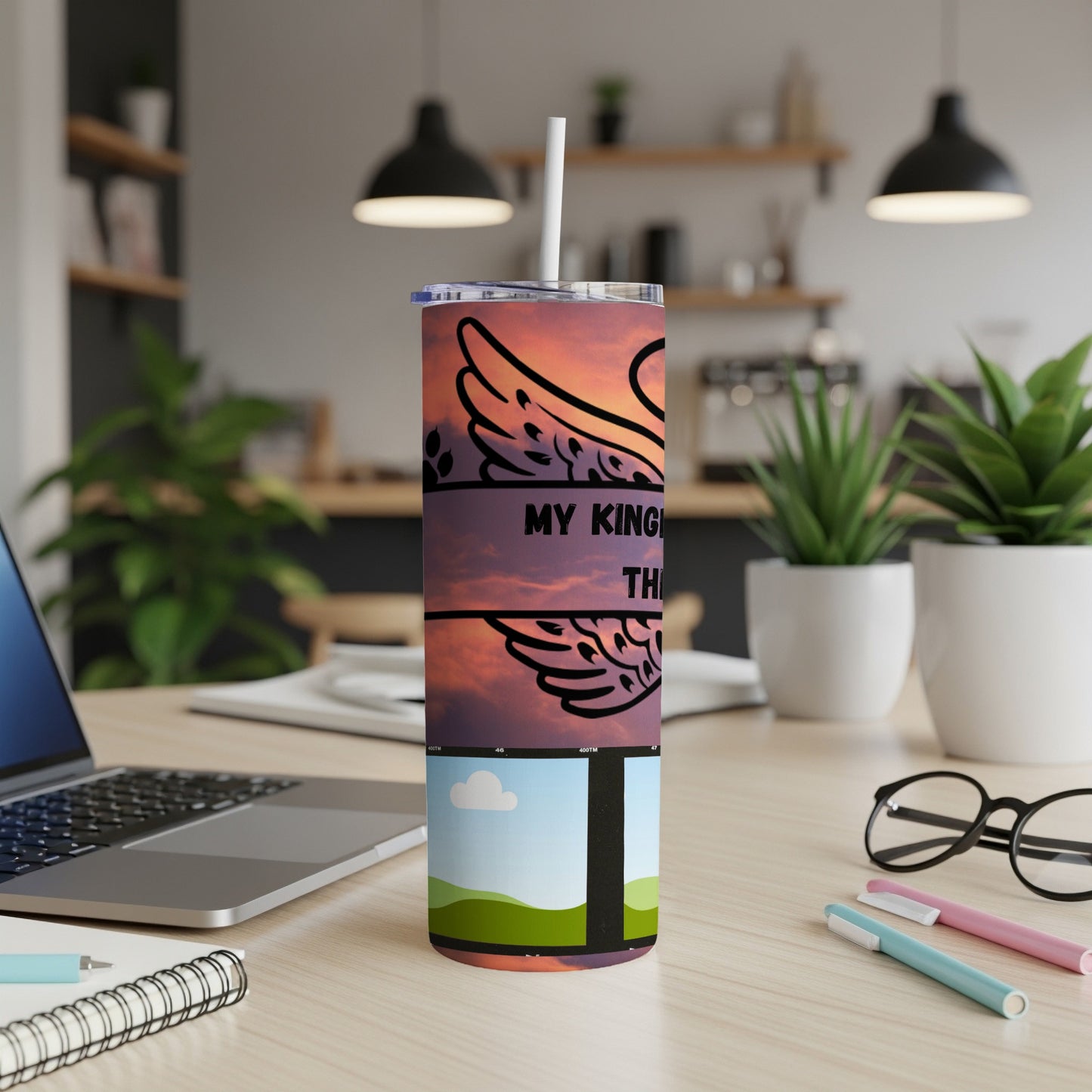 Tumbler with wings and text "MY KINGDOM" and "THE" against a sky background.