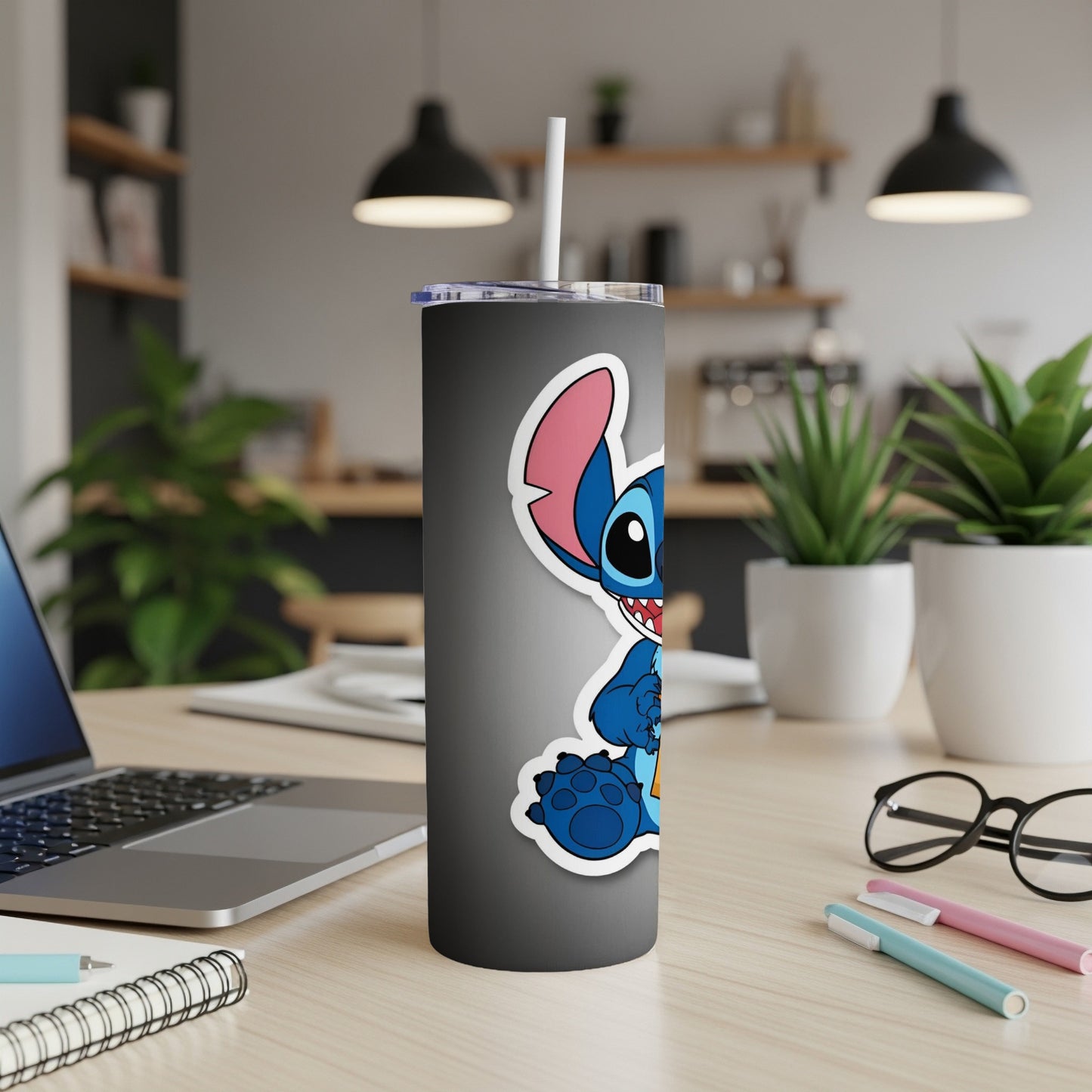Stitch character sticker on a dark gray tumbler with straw.