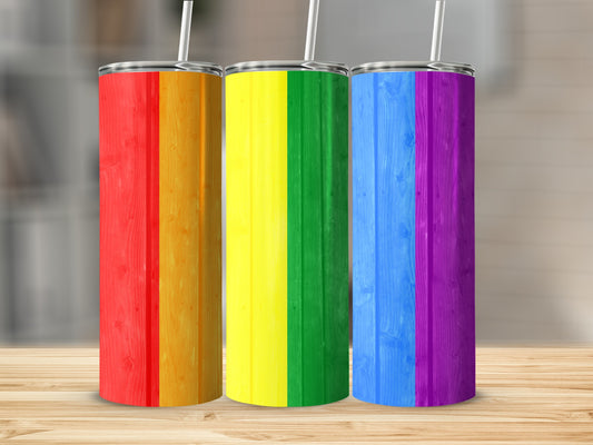 Three tumblers with rainbow flag colors and wood grain texture.