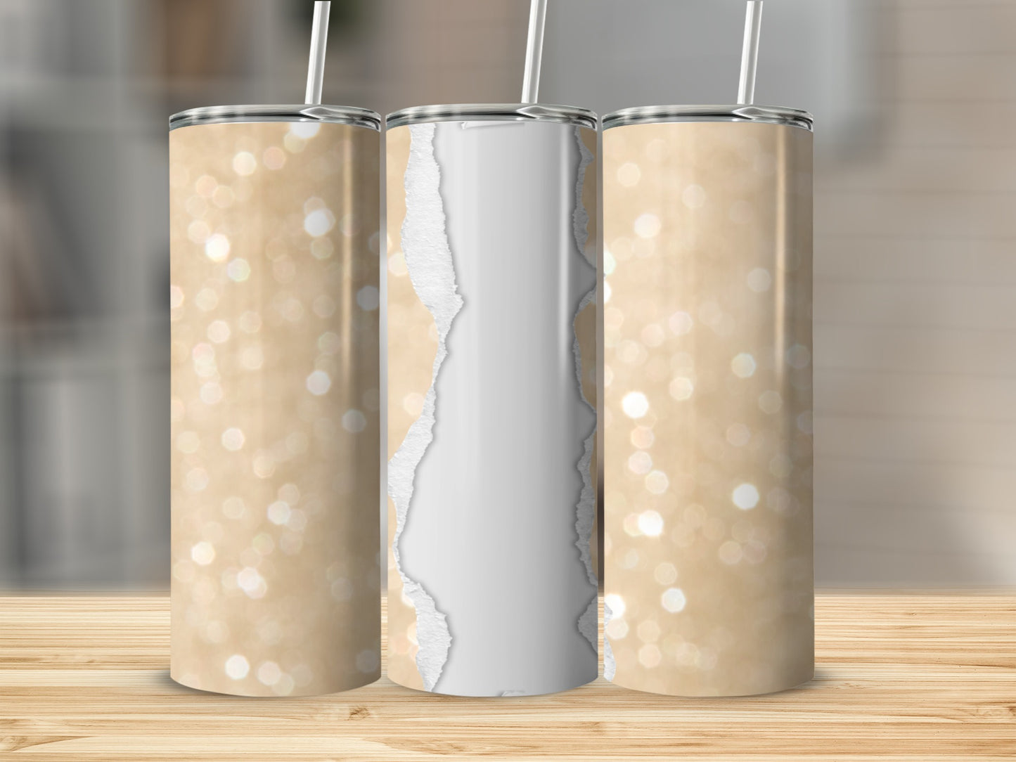 Three golden glitter tumblers with torn paper design, two on left and right.