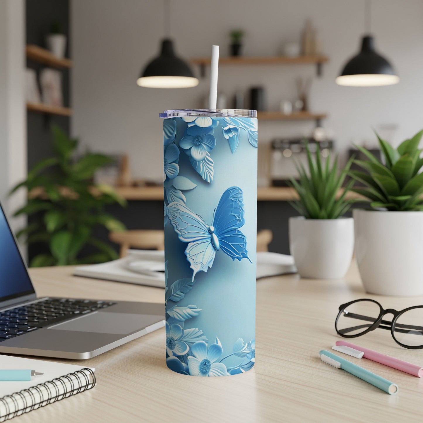 Blue floral tumbler with a butterfly design.
