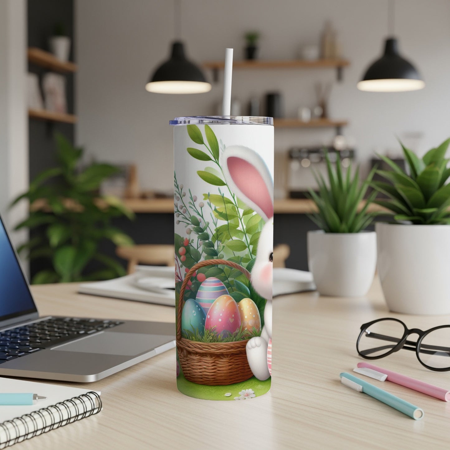 Easter bunny and painted eggs on a tumbler with straw.