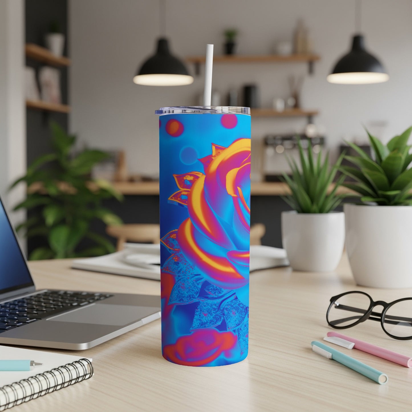 Blue tumbler with a vibrant, abstract rose design and straw.