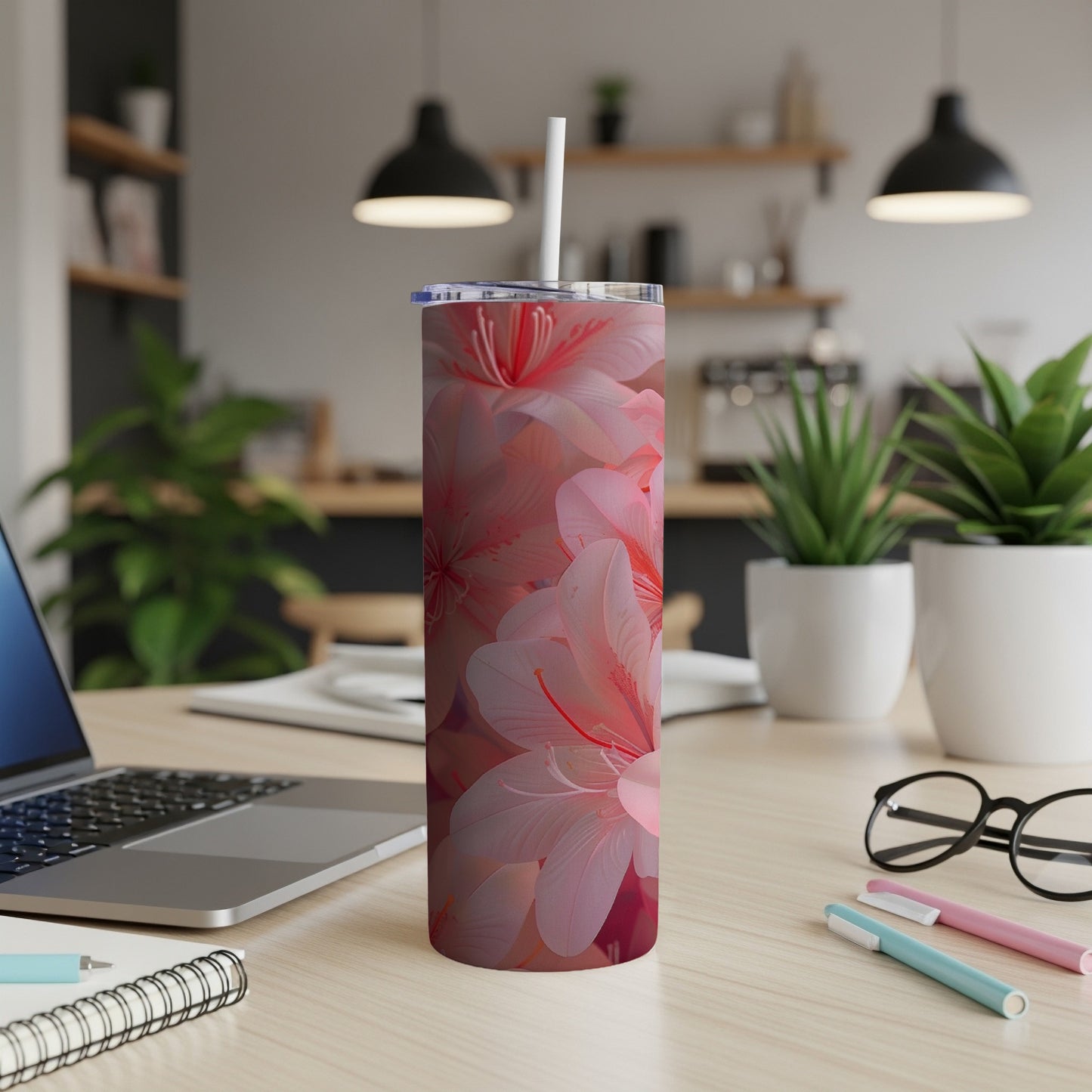 Pink floral pattern on a white insulated tumbler with straw.