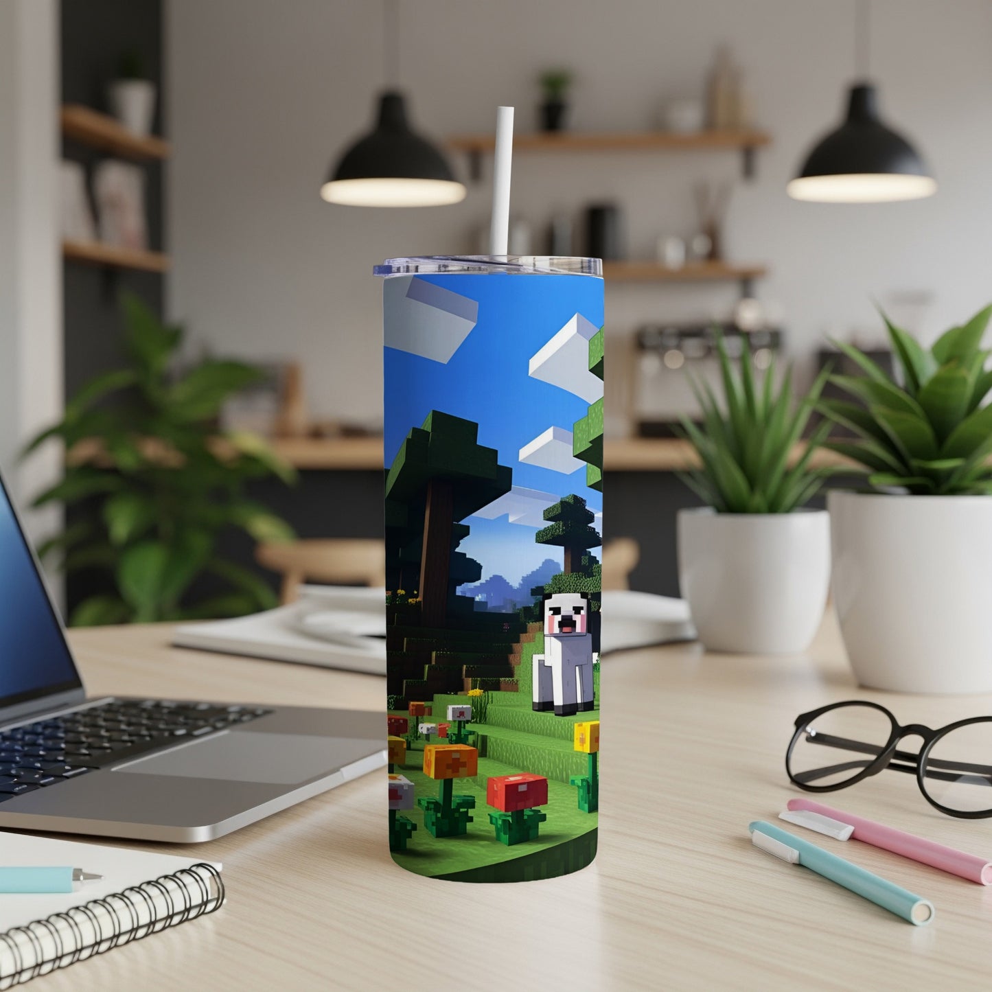 Minecraft tumbler with a Creeper, trees, and flowers on a desk.