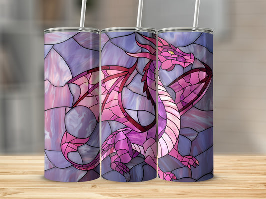 Stained glass dragon tumbler with pink and purple hues on a wooden surface.