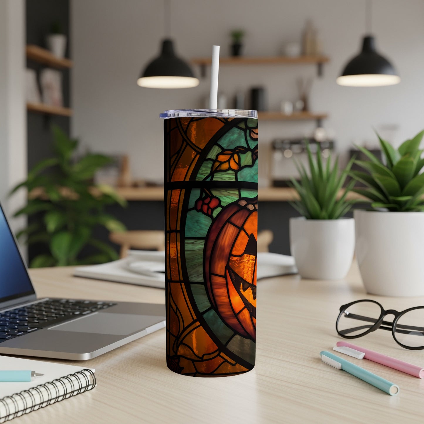 Stained glass tumbler with a jack-o'-lantern design.
