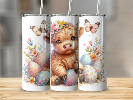Fluffy highland cow with Easter eggs and butterflies on a tumbler.