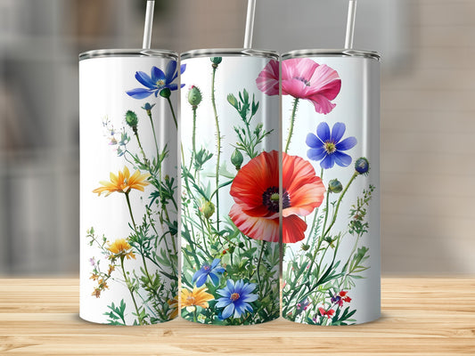 Three white tumblers with colorful wildflowers, including red poppies and blue and yellow flowers.