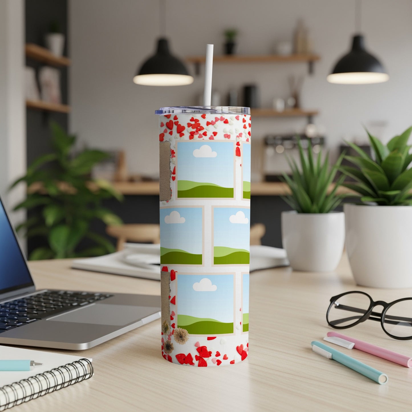 Tumbler with heart pattern and multiple photo frames on a desk.