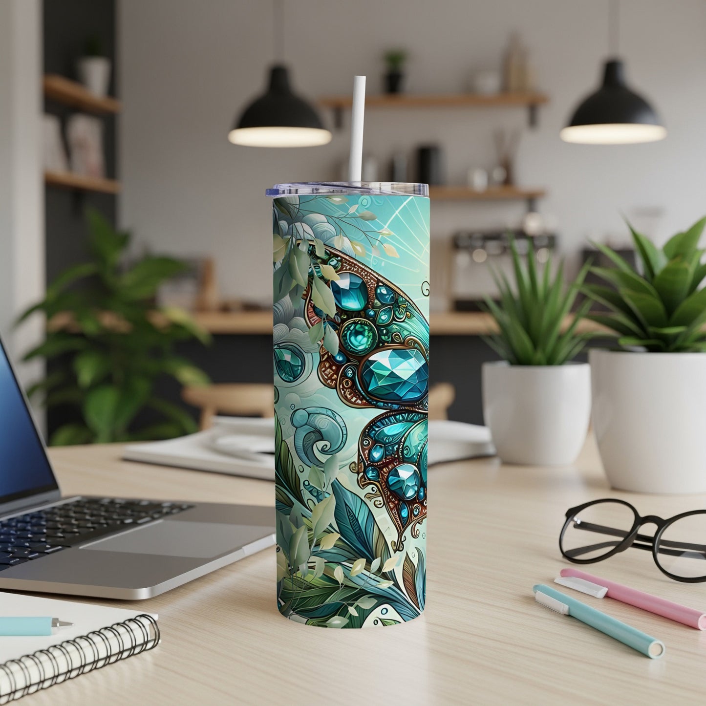Teal tumbler with butterfly and floral design, white straw.